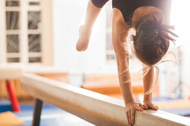 Girl gymnast trains in the gym